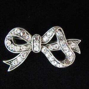 Vintage clear rhinestone bow brooch in silver tone setting - Mid Century Modern